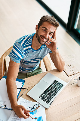 Buy stock photo High angle portrait of a handsome young male entrepreneur working from his home office