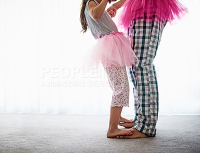 Buy stock photo Cropped shot of an unrecognizable father and his daughter dancing at home