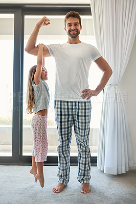 Buy stock photo Full length shot of an adorable little girl hanging from her father's bicep at home