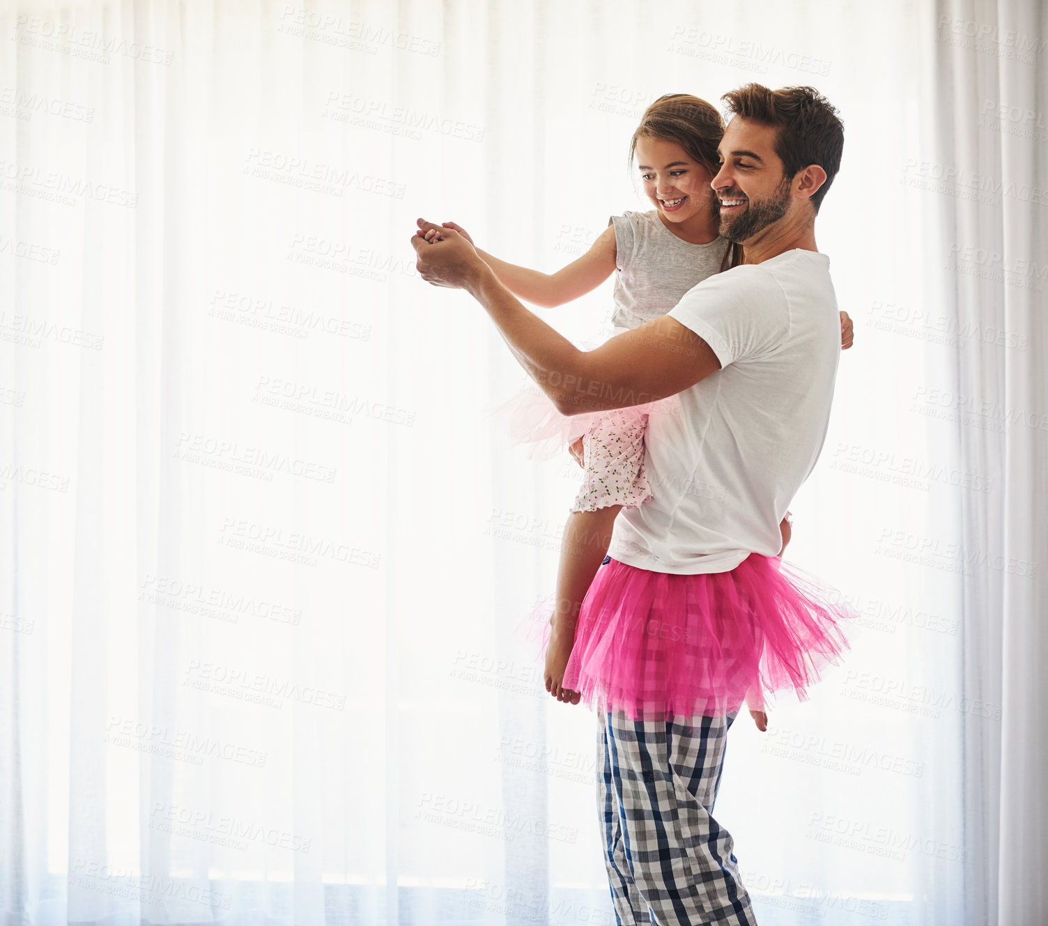 Buy stock photo Cropped shot of a handsome young man and his daughter dancing at home