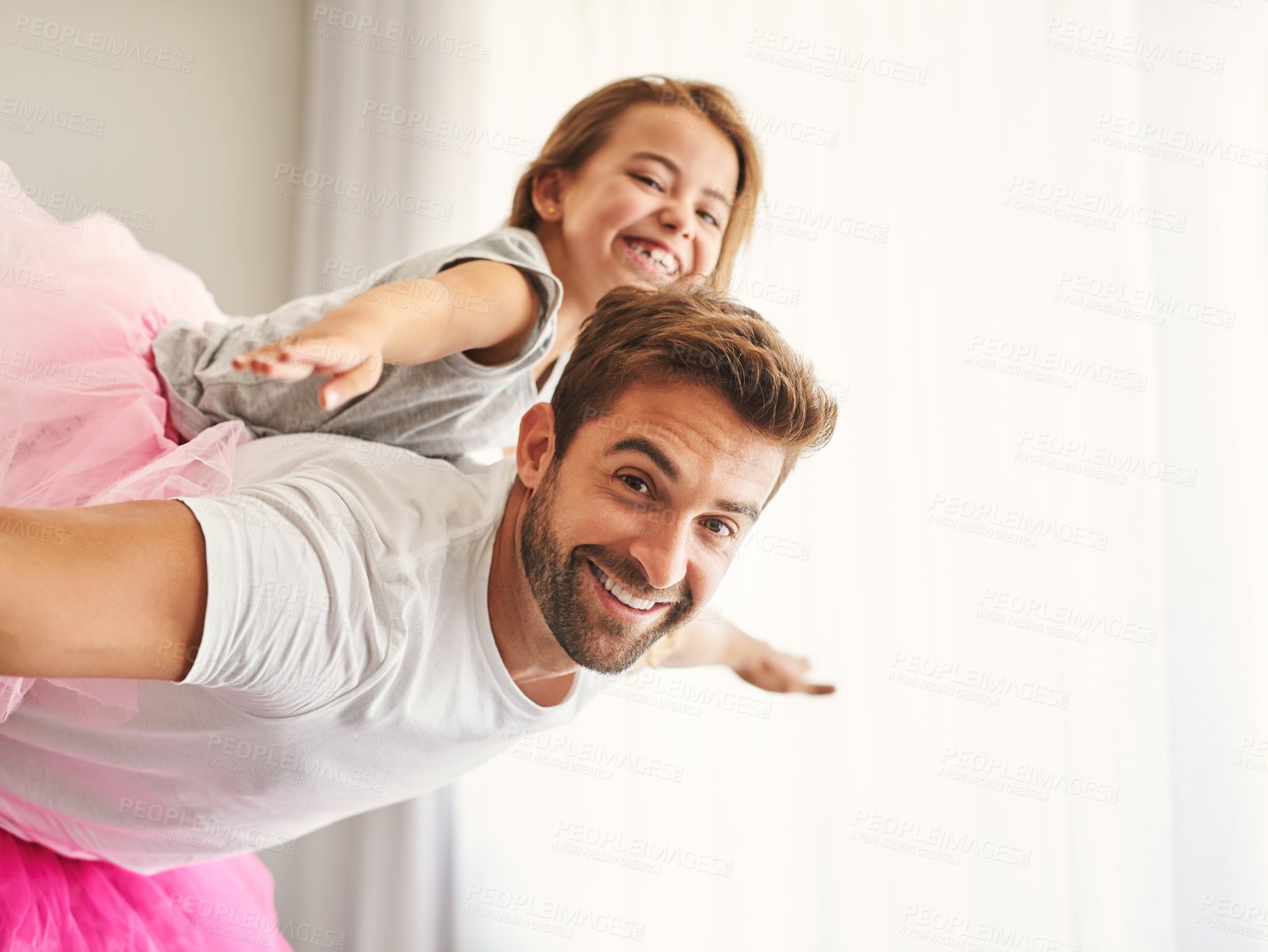Buy stock photo Cropped portrait of a handsome young man piggybacking his daughter at home