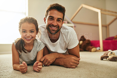 Buy stock photo Portrait of a handsome young man and his daughter lying on her bedroom floor