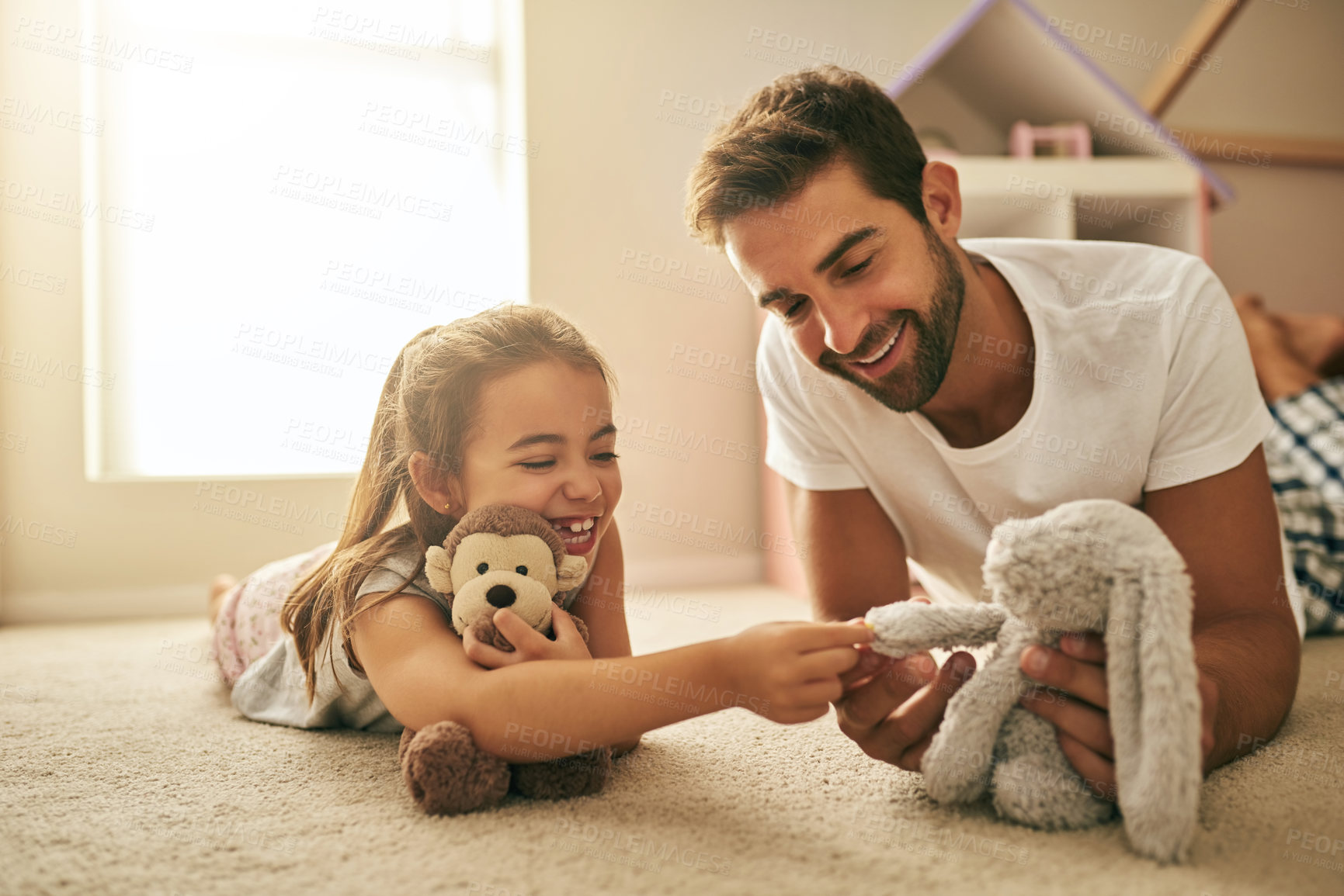 Buy stock photo Shot of a handsome young man and his daughter playing with stuffed toys on her bedroom floor