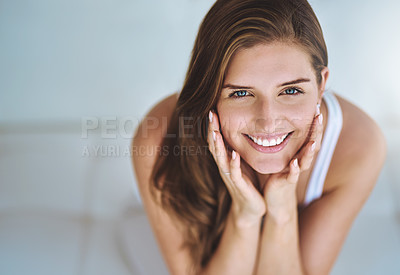 Buy stock photo Cropped shot of a young woman relaxing on her sofa at home