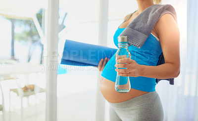 Buy stock photo Cropped shot of a pregnant woman getting ready to workout at home