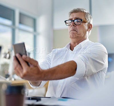 Buy stock photo Mature man, phone and vision problem, eyesight and myopia or glaucoma in business office. Mobile, person and poor sight, squinting and manager struggle with reading blurry email online with glasses