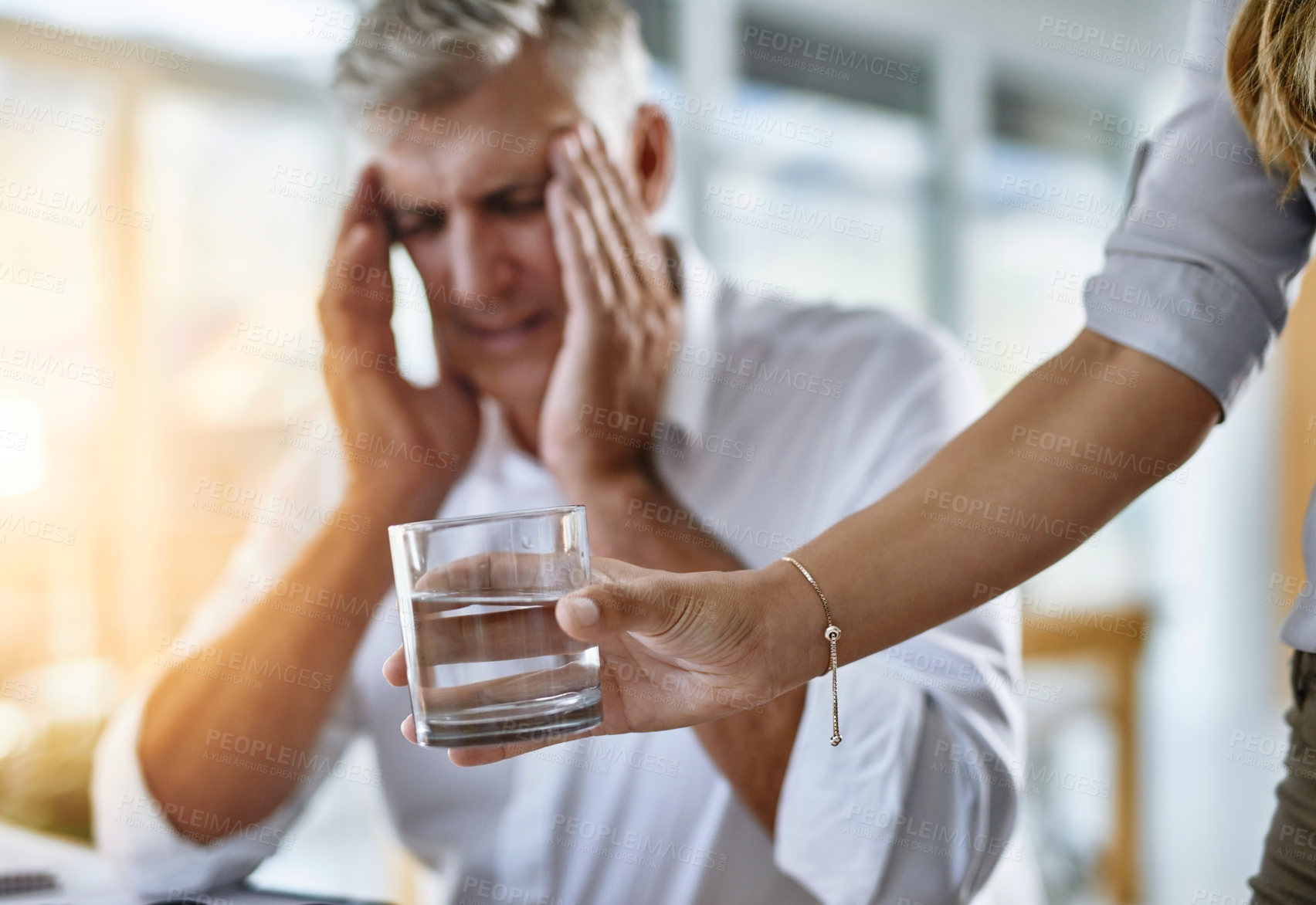 Buy stock photo Business, hand and headache of mature man in office with help from assistant or employee. Glass, stress or water and overworked corporate manager in workplace with symptoms of burnout migraine