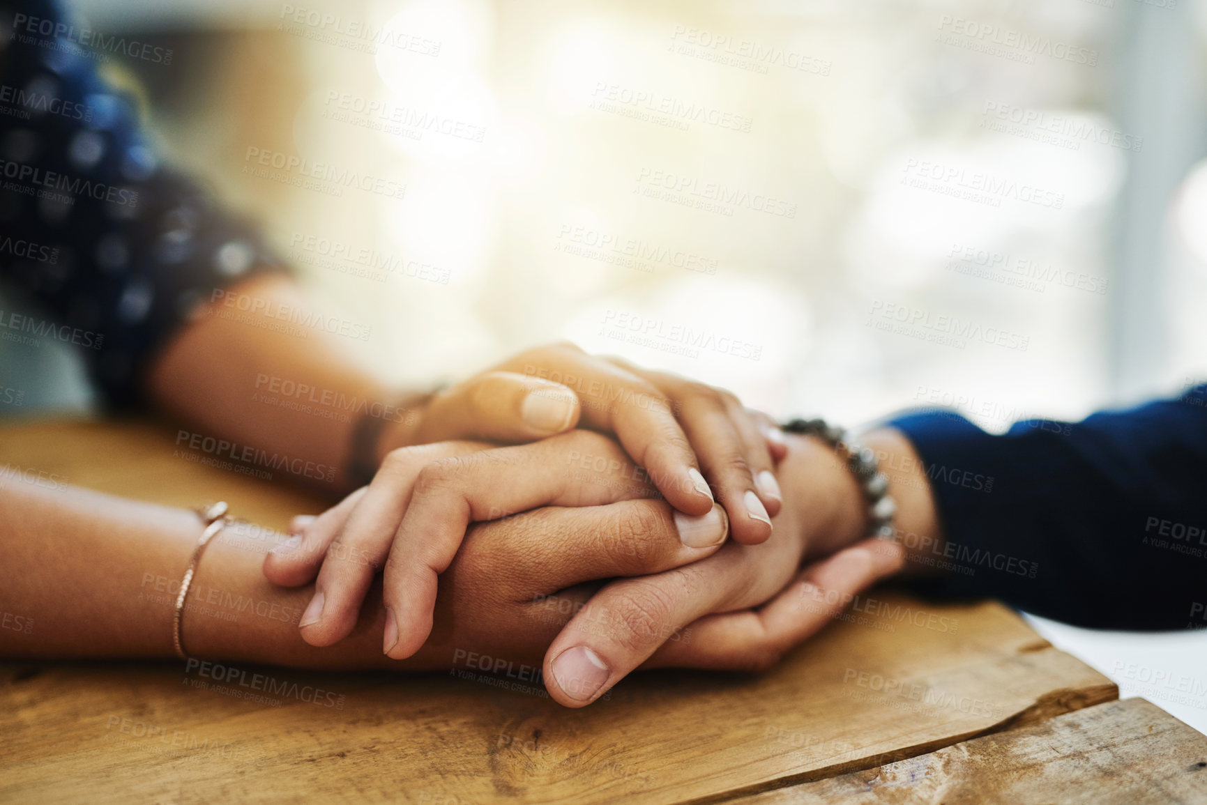Buy stock photo Holding hands, support and comfort of two people talking through a difficult problem. Closeup of friends showing care and love through a hard time, consoling each other and bonding