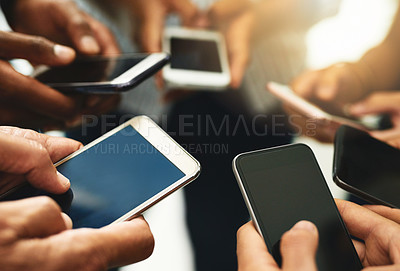 Buy stock photo Closeup of business people hands typing on a phone, texting on social media or reading emails or online news. Diverse group of colleagues social networking, looking at copyspace mobile screens.
