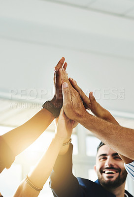 Buy stock photo Cropped shot of a group of businesspeople high fiving in an office