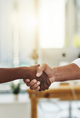 Buy stock photo Closeup shot of two unrecognizable businessmen shaking hands in an office