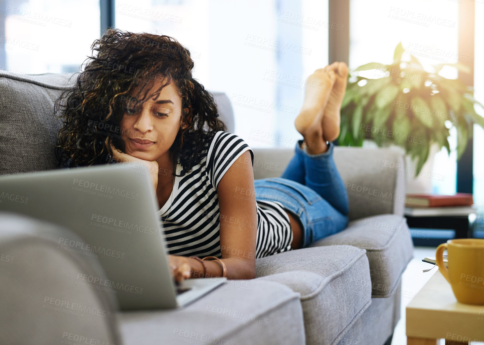 Buy stock photo Happy, woman or student with laptop on sofa for distance learning, remote work or online lesson at home. Smile, female person and computer for studying, scholarship and research for college essay