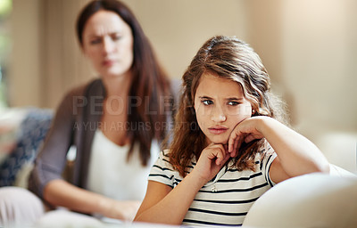 Buy stock photo Cropped shot of a young girl being reprimanded by her mother at home