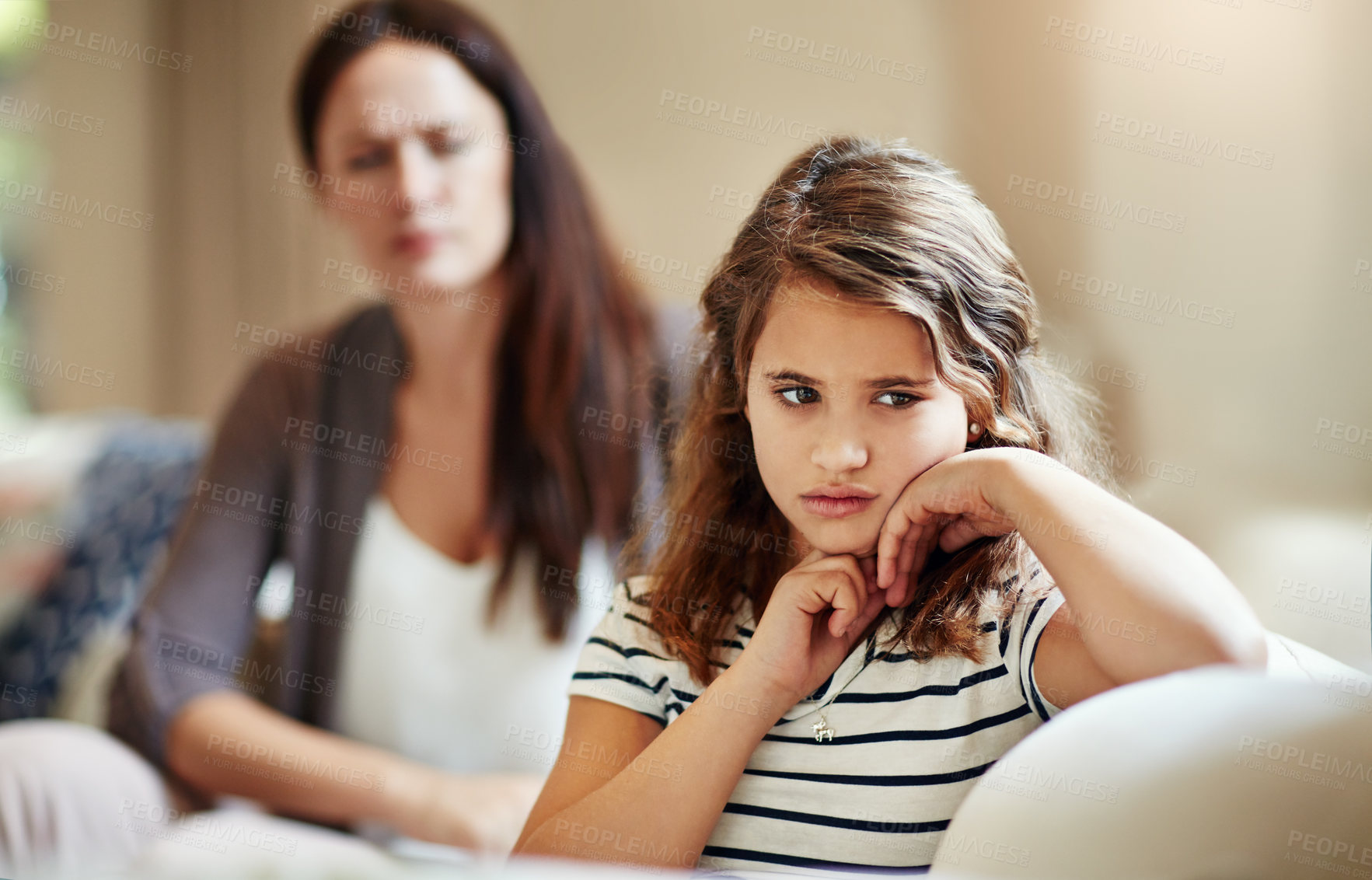 Buy stock photo Cropped shot of a young girl being reprimanded by her mother at home