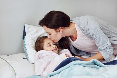Buy stock photo Cropped shot of a mother giving her little girl a kiss on her forehead while sleeping