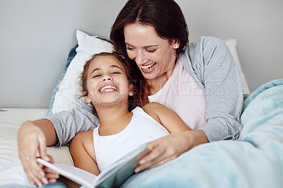 Buy stock photo Cropped shot of a mother and daughter reading a bedtime story together
