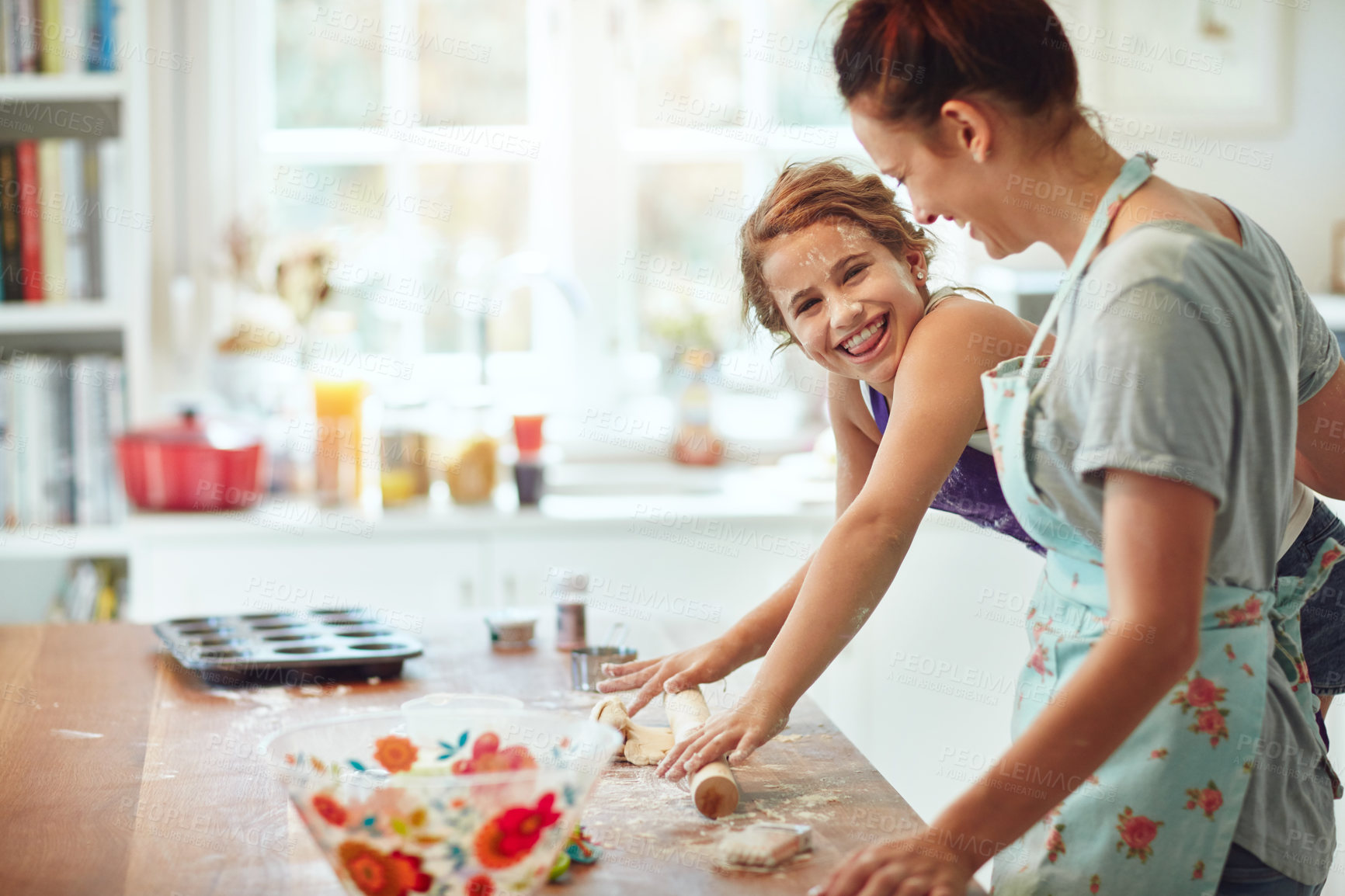 Buy stock photo Shot of a mother and daughter preparing food in the kitchen at home