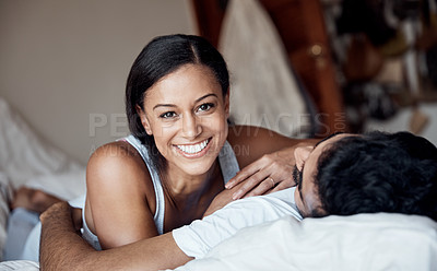 Buy stock photo Portrait of a young woman lying on a bed with her husband at home