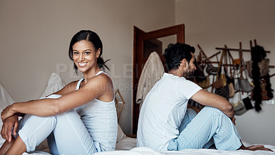 Buy stock photo Portrait of a young woman sitting on a bed with her husband at home