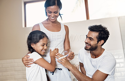 Buy stock photo Shot of parents showing their little daughter a pregnancy test stick at home