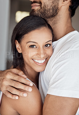 Buy stock photo Portrait of a young woman hugging her husband at home