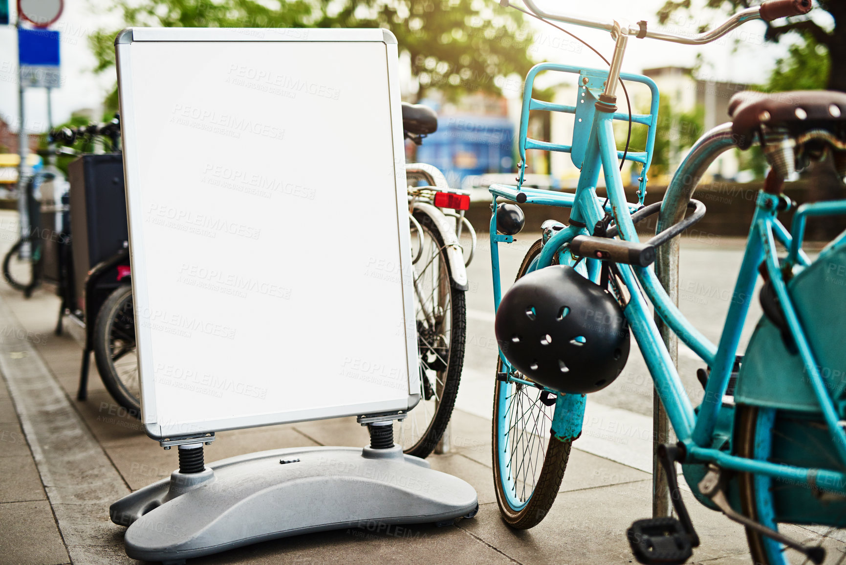 Buy stock photo Bike, mockup and sign at rental station for commute, tourism or safe public transportation in city. Bicycle, poster and space with retail service for holiday, travel or vacation in urban town