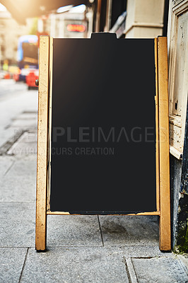 Buy stock photo Shot of a sidewalk sign with space for you to add your own text