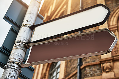 Buy stock photo Building, arrow and road sign outdoor for direction, location and travel guide in city with mockup. Street, symbol and infrastructure for drive, way and path in urban town with pole, safety and route