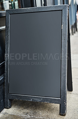 Buy stock photo Shot of a sidewalk sign with space for you to add your own text