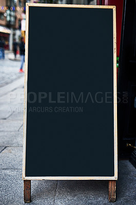 Buy stock photo Shot of a sidewalk sign with space for you to add your own text