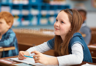 Buy stock photo Shot of an elementary school girl working in class