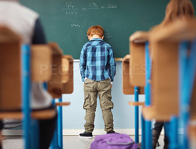 Buy stock photo Rear view, boy student in detention with head on chalkboard and in classroom of school building. Anxiety or depressed for time out, math problems to solve and male kid with back to class.