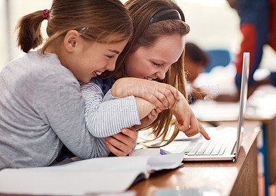 Buy stock photo Shot of elementary school kids using a laptop while working in class