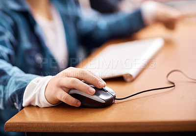 Buy stock photo Shot of an unidentifiable elementary school boy using a computer while working in class