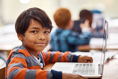 Buy stock photo Portrait of an elementary school boy using a laptop while working in class