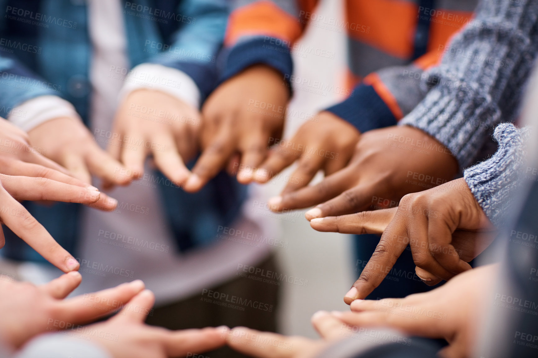 Buy stock photo Closeup shot of a group of unrecognizable elementary school kids making peace signs in a huddle