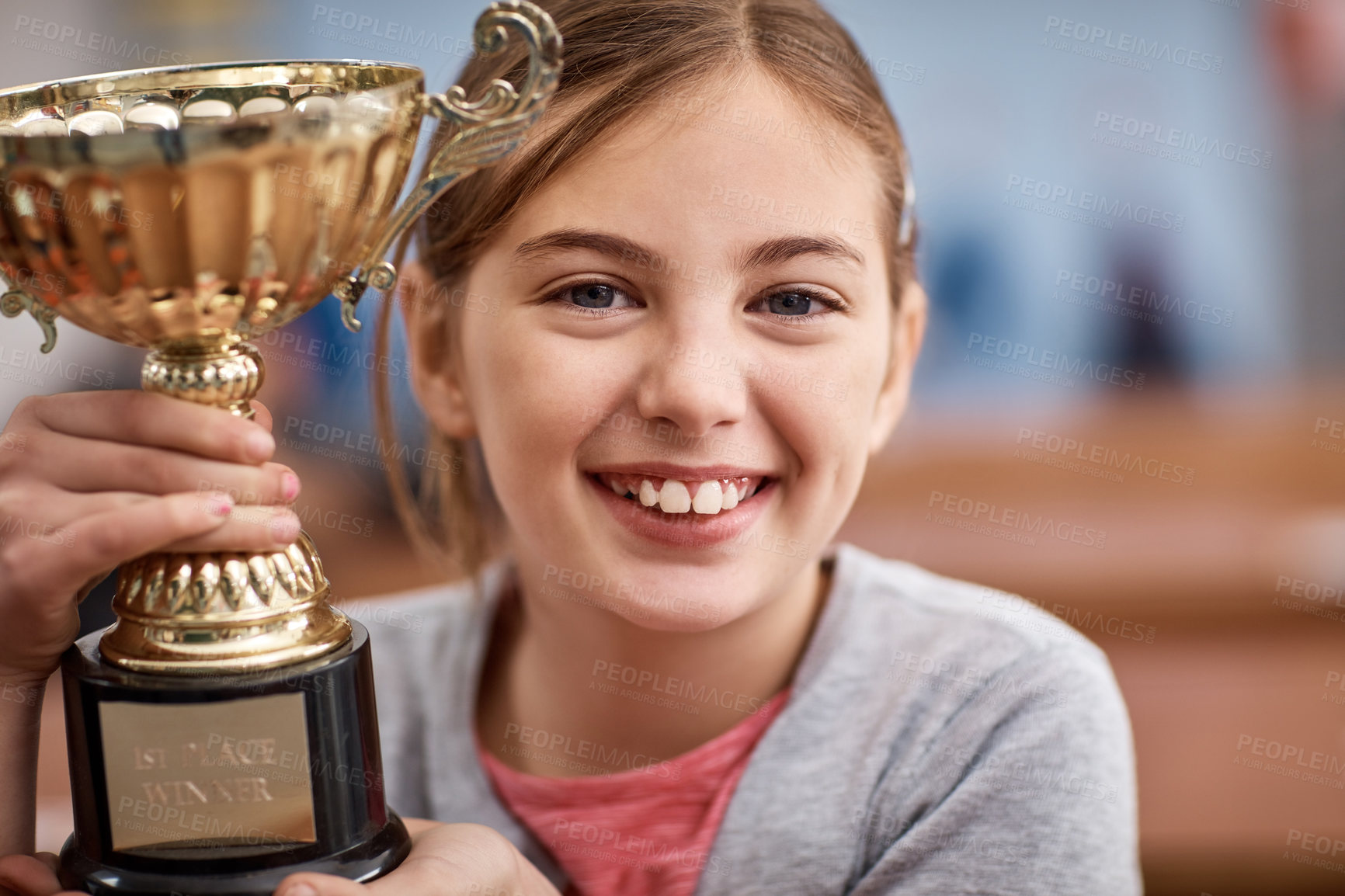 Buy stock photo Portrait of an elementary school girl holding a trophy in class