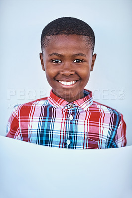 Buy stock photo Portrait of a little boy holding a blank board against a grey background