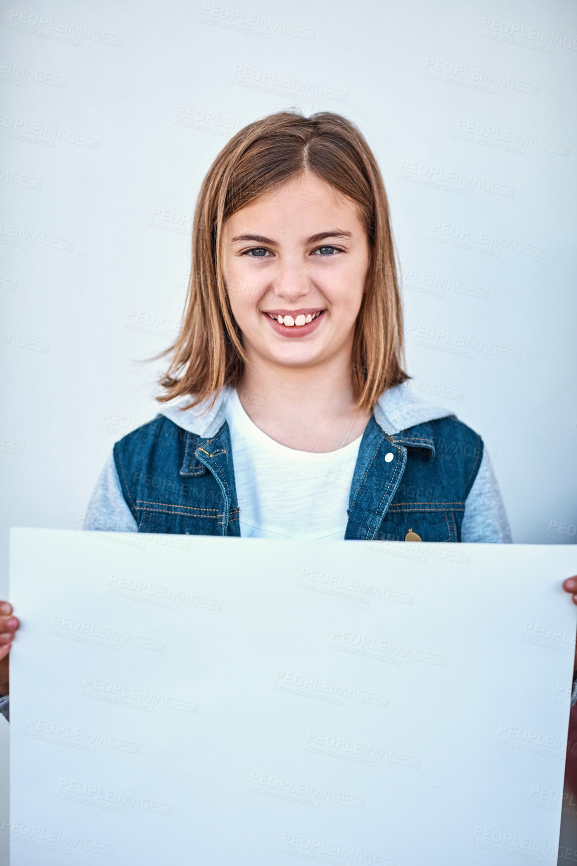 Buy stock photo Portrait of a little girl holding a blank board against a grey background