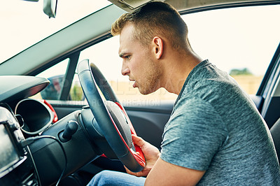 Buy stock photo Shot of a young man having troubles with his car while driving