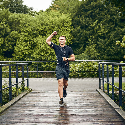 Buy stock photo Portrait of a sporty young man cheering while exercising outdoors