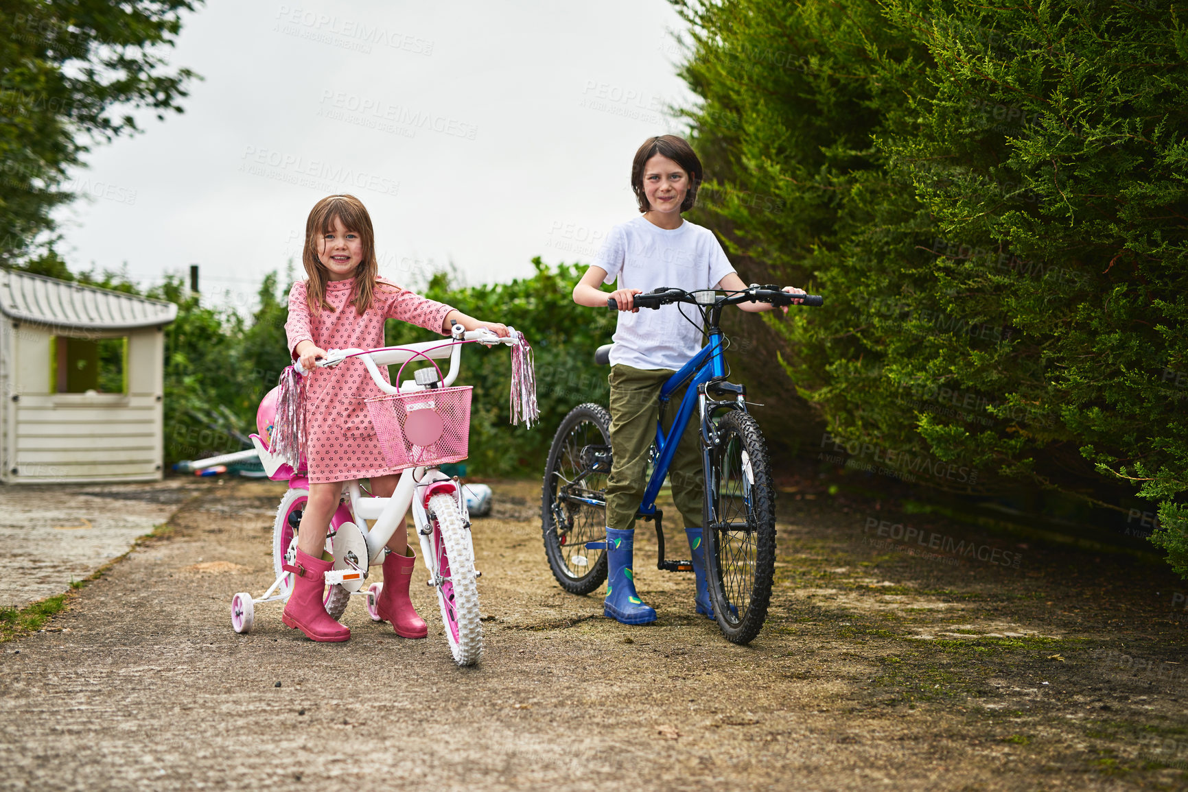 Buy stock photo Portrait, children and playful with bicycle in backyard, family home or garden as siblings for fun in USA. Kids, adventure and happiness with bonding, together and excited on weekend for development