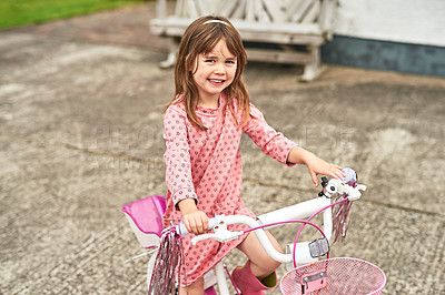 Buy stock photo Portrait, child and playful with bicycle in backyard, family home or garden as little girl for fun in USA. Kids, adventure and happiness with practice, outdoor and excited on weekend for development