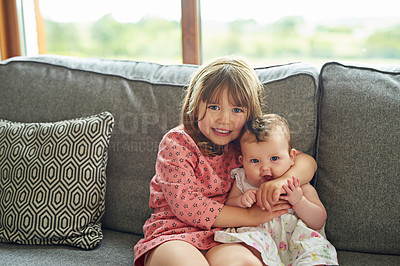 Buy stock photo Portrait of a little girl bonding with her baby sister at home