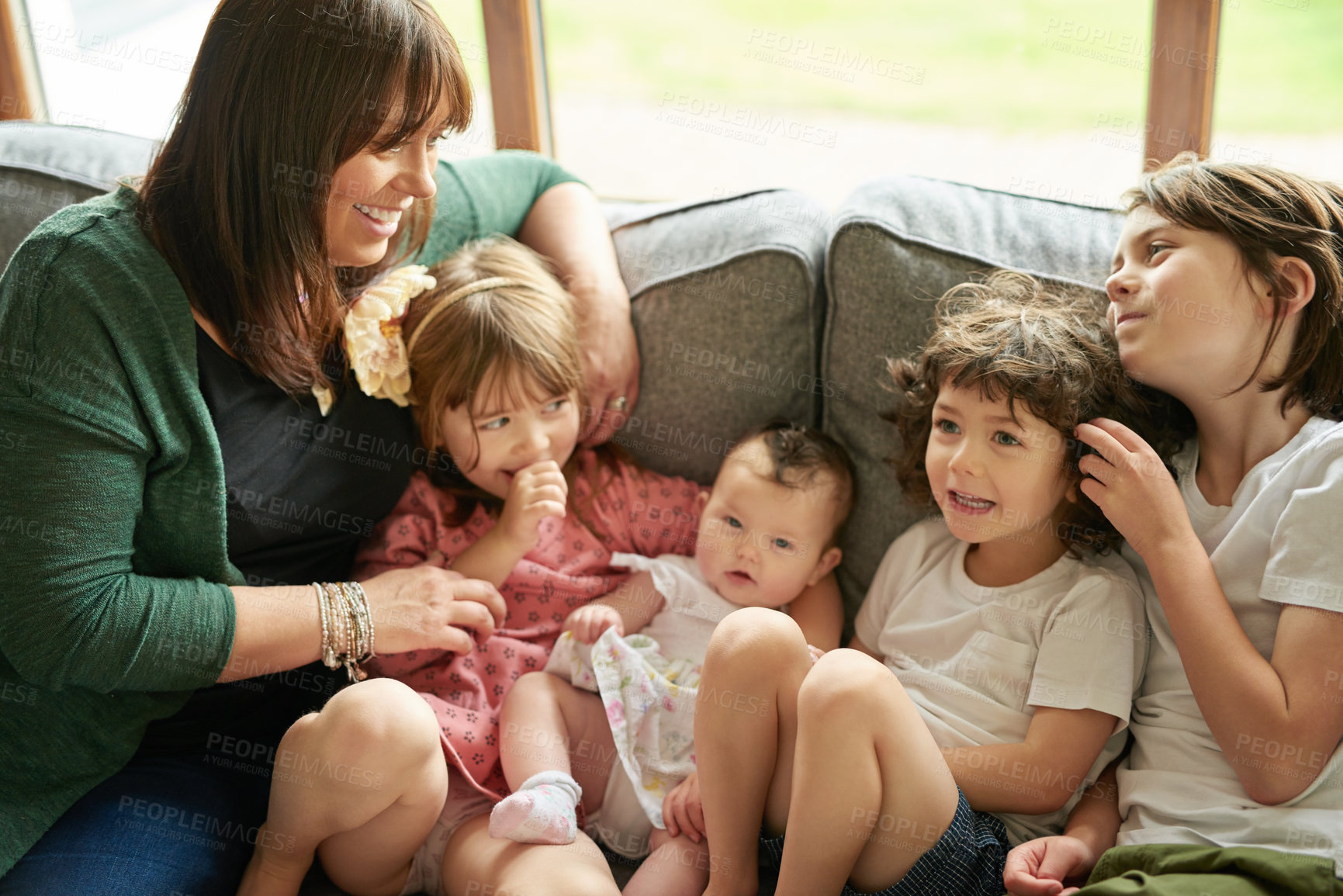 Buy stock photo Shot of a mother bonding with her four little children at home