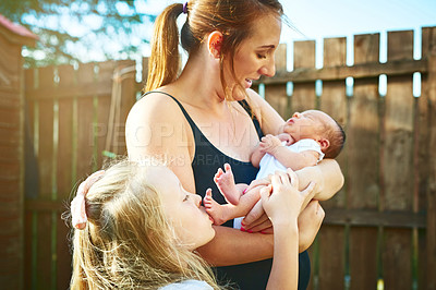 Buy stock photo Mother, sister and outdoor newborn baby, sleep and support child for development in home garden. Mom, nap and holding kid for relationship connection by bonding, backyard and love for infant or care