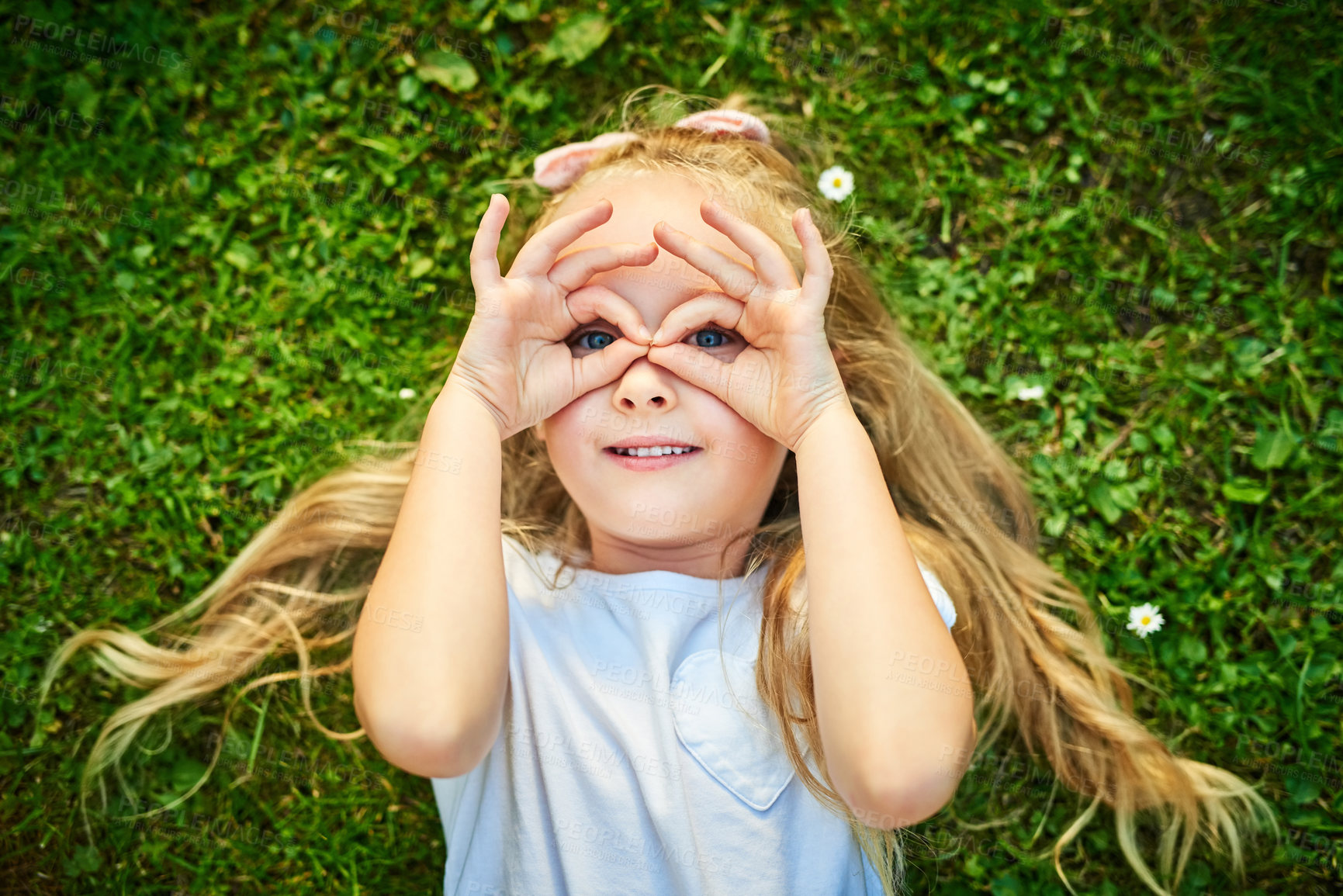 Buy stock photo Girl, portrait and finger for outdoor glasses, sightseeing and playing detective game in nature. Female person, child development and above frame, explore countryside and relax on grass to imagine