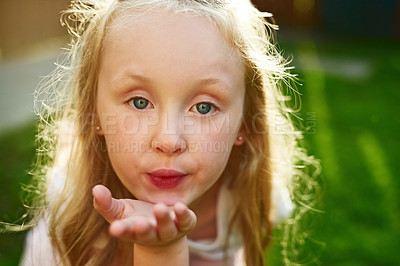 Buy stock photo Kid, portrait and blowing kiss outdoor in garden for love, kindness and caring with lens flare. Girl, child and hand gesture for affection, playing and confidence in backyard lawn in New York home