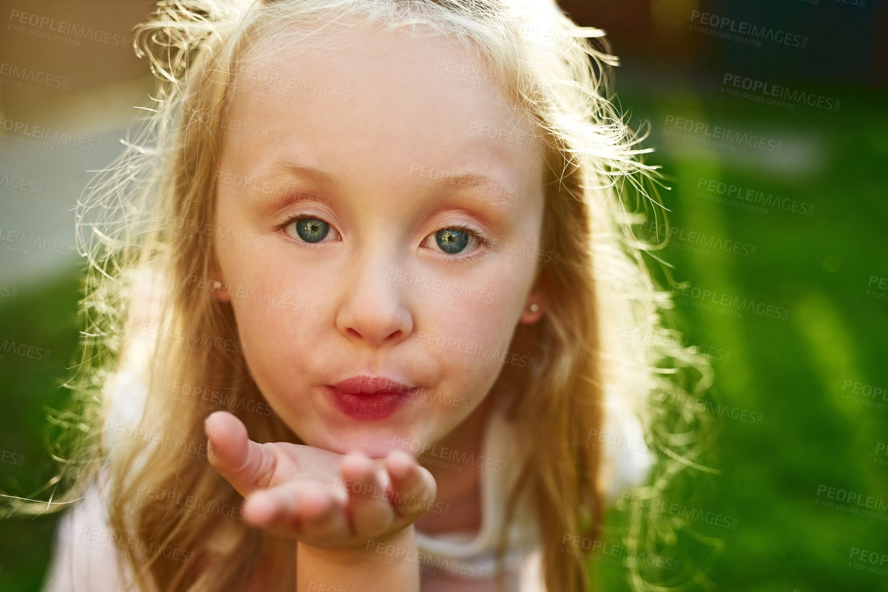 Buy stock photo Kid, portrait and blowing kiss outdoor in garden for love, kindness and caring with lens flare. Girl, child and hand gesture for affection, playing and confidence in backyard lawn in New York home