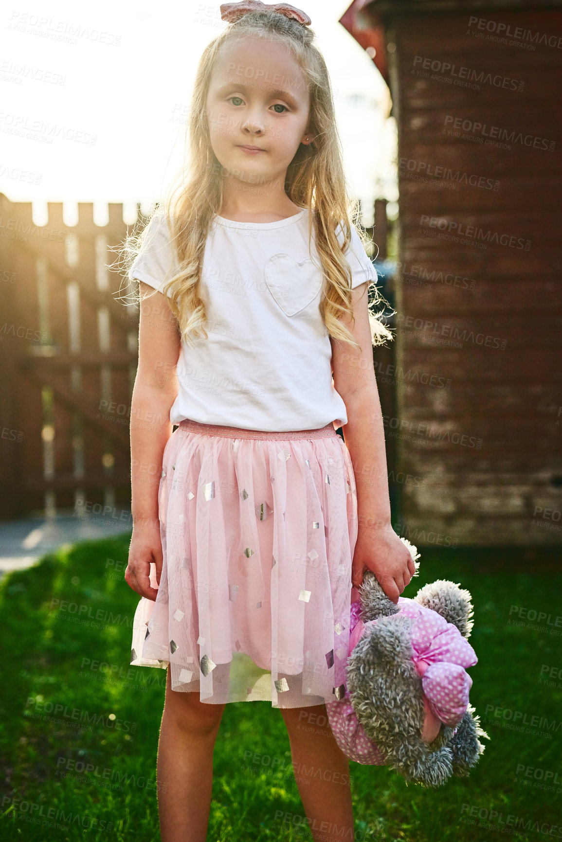 Buy stock photo Girl, love and outdoor portrait with teddy bear, playing games and toy for fantasy adventure. Female person, child and backyard freedom for development, together and friend for safety or bonding